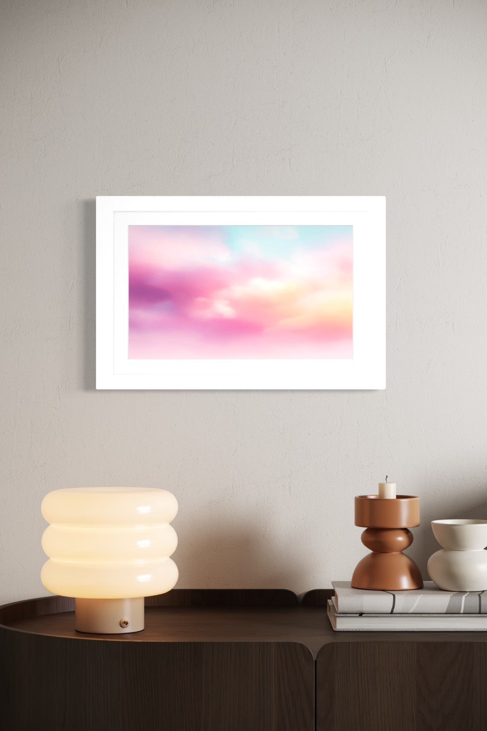 Candy Clouds pastel sky art framed and shown on a wall above a curved wood credenza with a bubble lamp