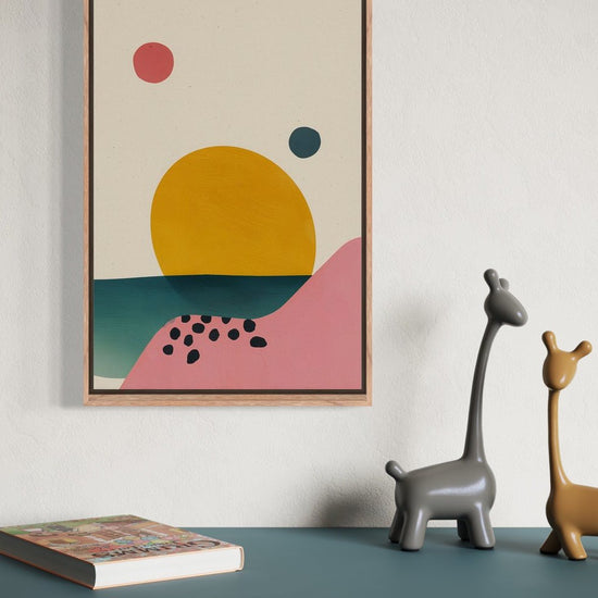 Abstract Sunset illustration in an oak frame shown on a wall above a teal sideboard with giraffe figurines