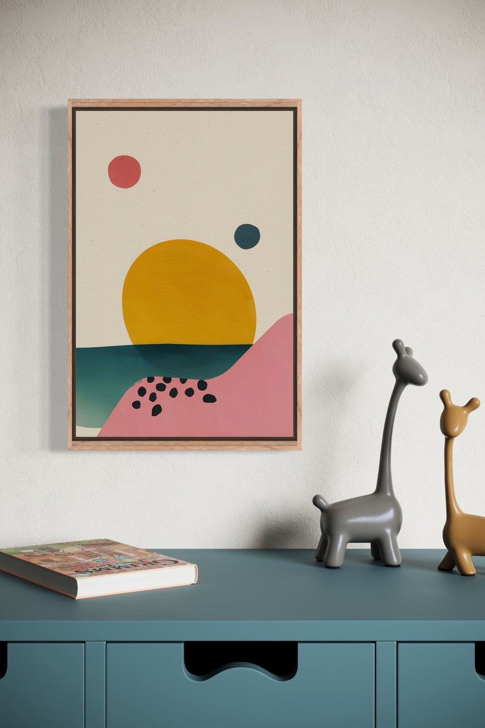 Abstract Sunset illustration in an oak frame shown on a wall above a teal sideboard with giraffe figurines