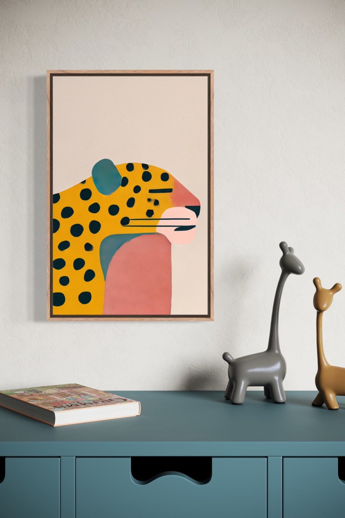 Jaguar illustration in an oak frame shown on a wall above a teal sideboard with giraffe figurines